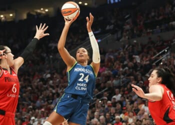 Napheesa Collier shoots a basketball as players surround her on the court in Portland, Oregon on August 12, 2026.