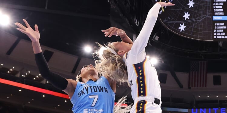 Sophie Cunningham of the Indiana Fever is fouled by DiJonai Carrington of the Chicago Sky during the first half at United Center on Aug. 8, 2026, in Chicago, Illinois.