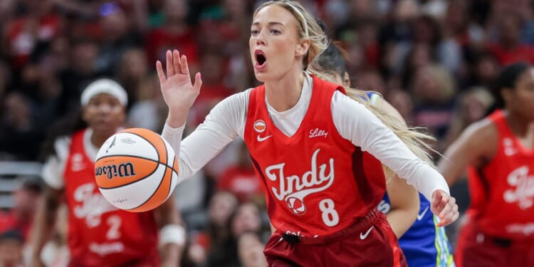 Sophie Cunningham #8 of the Indiana Fever reaches for the ball during the first half Friday against the Dallas Wings at Gainbridge Fieldhouse in Indianapolis, Indiana.
