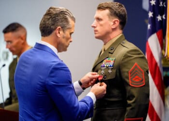 Secretary of War Pete Hegseth pins a medal on Marine Gunnery Sgt. Jonathan Eby, right, during a Pentagon event Wednesday to honor Marines who were serving during the 2021 Abbey Gate bombing in Kabul, Afghanistan.