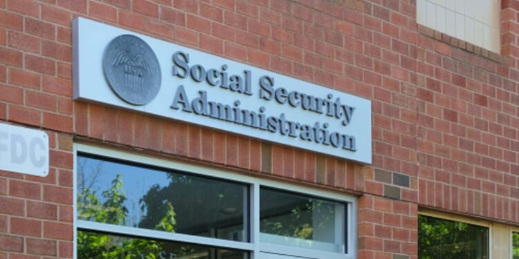 A brick Social Security Administration building stands in the sunshine.