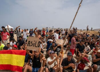 Migrants, mainly Moroccan, gather in a protest asking for asylum in El Trampolin beach on Aug. 16, 2026, in Ceuta, Spain.