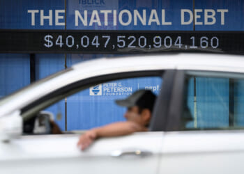 An electronic display shows the national debt in Washington, DC on August 19, 2026. The US national debt exceeded a record 40 trillion USD. The US gross national debt has surged past $40 trillion for the first time, government data showed Wednesday, outstripping earlier forecasts at a pace fuelled in part by President Donald Trump's invalidated tariffs. The uptick in borrowing comes as longer term US obligations linked to social security and health care have been growing, while interest payments have climbed as well. (Photo by Mandel NGAN / AFP via Getty Images)