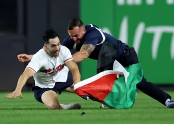 A fan carrying a Palestinian flag runs onto the field at 9:11 p.m. in the middle of the seventh inning at Yankee Stadium on Sept. 11, 2026, in the Bronx borough of New York City.
