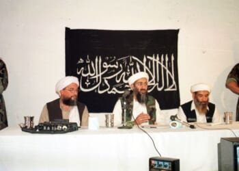 Armed men stand guard as terrorist Osama bin Laden and Ayman Al-Zawahiri address a news conference on May 26, 1998, in Afghanistan.