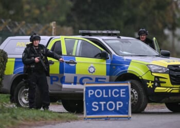 Armed police block a road leading into RAF Fairford air base outside London, which has been used to facilitate US strikes in Iran on Sept. 27, 2026.