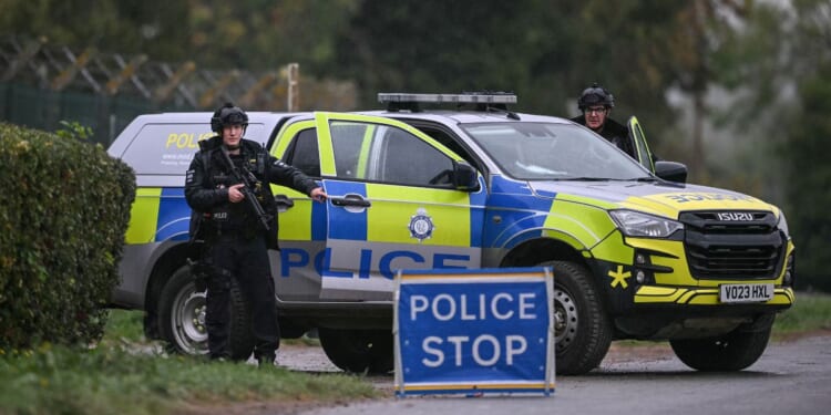 Armed police block a road leading into RAF Fairford air base outside London, which has been used to facilitate US strikes in Iran on Sept. 27, 2026.