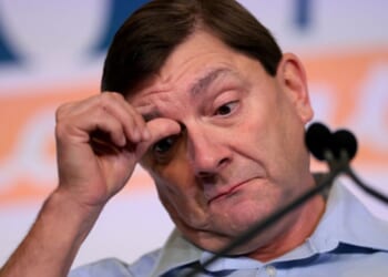 Troy Jackson, Senate candidate in Maine, scratches his face at a rally in Bangor, Maine on July 25, 2026.