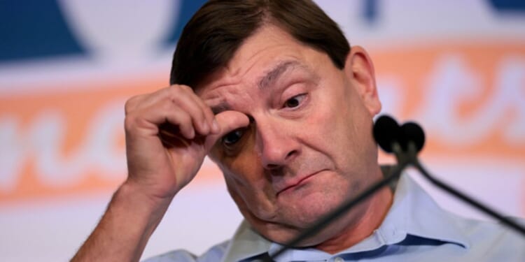 Troy Jackson, Senate candidate in Maine, scratches his face at a rally in Bangor, Maine on July 25, 2026.