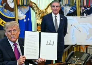 President Donald Trump, seen in an Aug. 27 photo with Secretary of the Interior Doug Burgum, displays an executive order he signed that day, changing the name of Lake Ontario to Lake America.