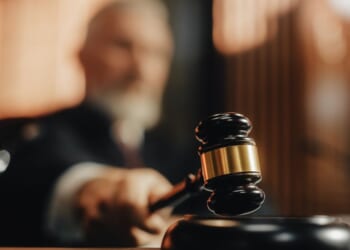 A judge brings down his gavel in a courtroom.