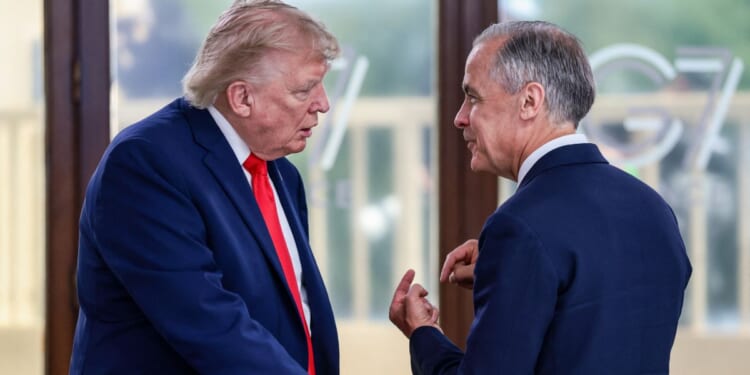 President Donald Trump speaks with Canadian Prime Minister Mark Carney during a work lunch as part of the G7 summit, in Evian, eastern France, on June 16, 2026.