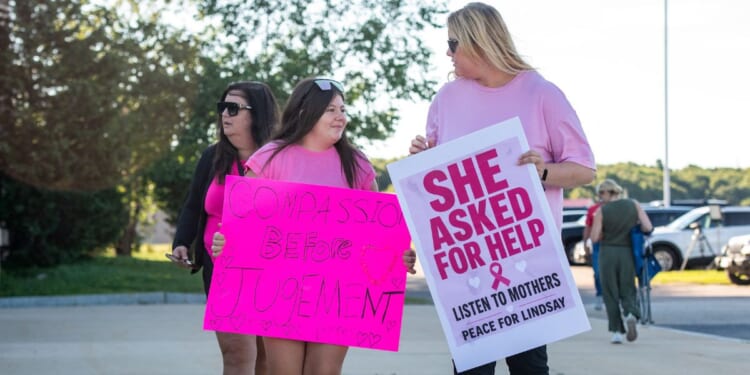 Supporters of Lindsay Clancy hold signs outside the Plymouth County Superior Court during Lindsay Clancy's murder trial in Plymouth, Massachusetts, on Aug. 26, 2026.