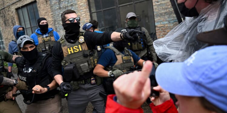 Agents from Immigration and Custom's Enforcement (ICE) clash with angry agitators in Chicago on June 4, 2025.