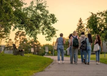 Students on a college campus walk together.