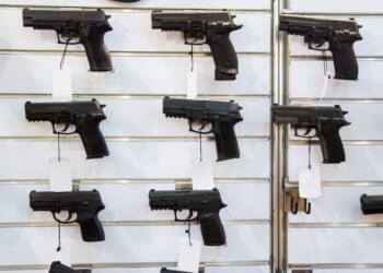 A gun wall rack with pistols.