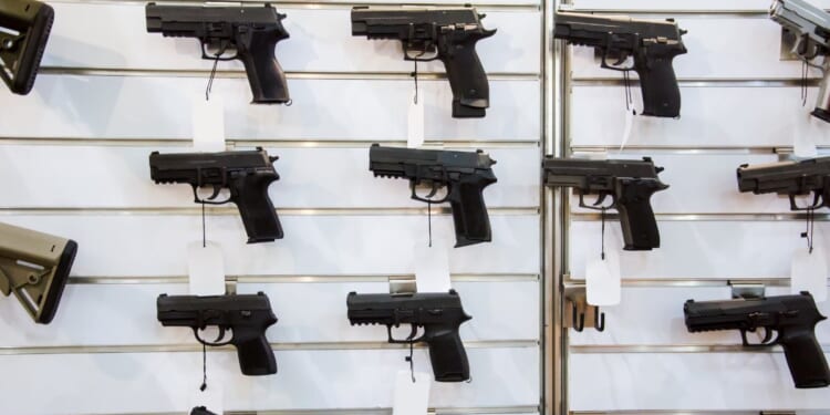 A gun wall rack with pistols.