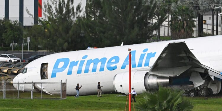 Officials investigate a recently crashed Amazon cargo plane at Miami International Airport on Sept. 6, 2026 in Miami, Florida.