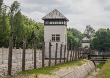 Dachau was fenced and guarded by SS guards. An escape was impossible.