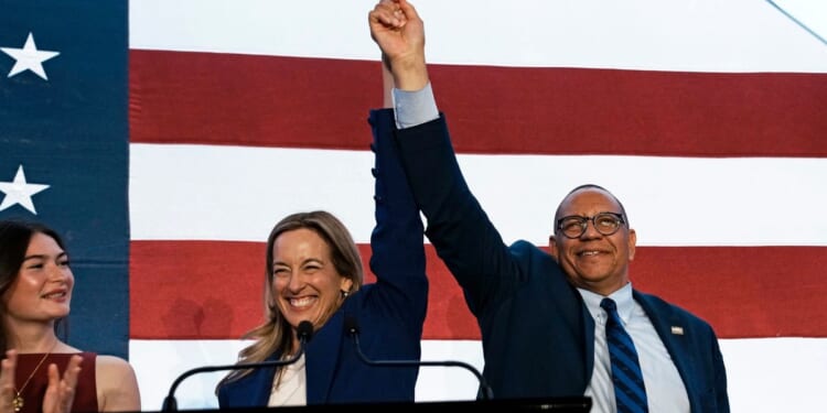 New Jersey Democratic Gov. Mikie Sherrill celebrates with Lt. Gov. Dale Caldwell after their win during an election night watch party at the Hilton East Brunswick Hotel on Nov. 4, 2025, in East Brunswick, New Jersey.