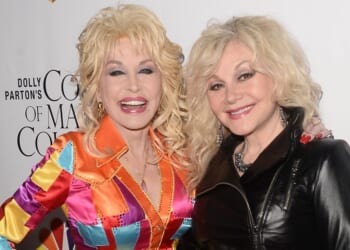 Actress/singer-songwriter Dolly Parton, left, and her sister, singer Stella Parton, arrive at the premiere of Warner Bros. Television's "Dolly Parton's Coat of Many Colors" at the Egyptian Theatre on Dec. 2, 2015, in Hollywood, California.