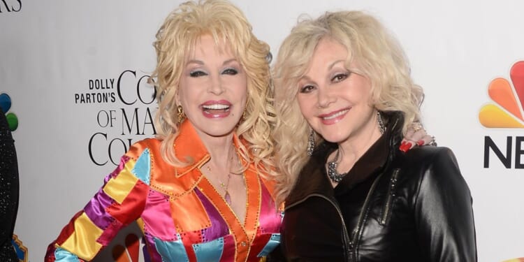 Actress/singer-songwriter Dolly Parton, left, and her sister, singer Stella Parton, arrive at the premiere of Warner Bros. Television's "Dolly Parton's Coat of Many Colors" at the Egyptian Theatre on Dec. 2, 2015, in Hollywood, California.