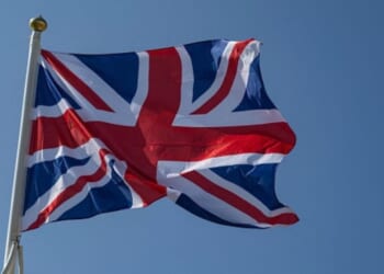 The flag of the United Kingdom waves in the wind on a beach in Northern France on June 18, 2025.