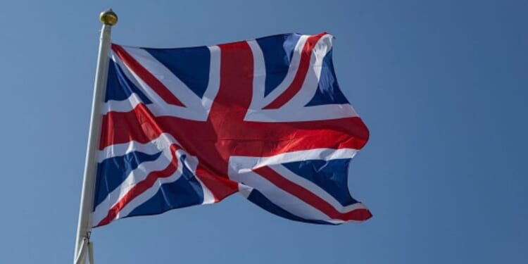 The flag of the United Kingdom waves in the wind on a beach in Northern France on June 18, 2025.