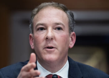 Under Administrator Lee Zeldin (pictured), the EPA is dropping greenhouse gas emission regulations established under President Joe Biden, noting that the Clean Air Act doesn't allow the EPA to regulate for climate change. Pictured: Zeldin, a man in a suit and tie speaks, gesturing with his hand. The background is out of focus.