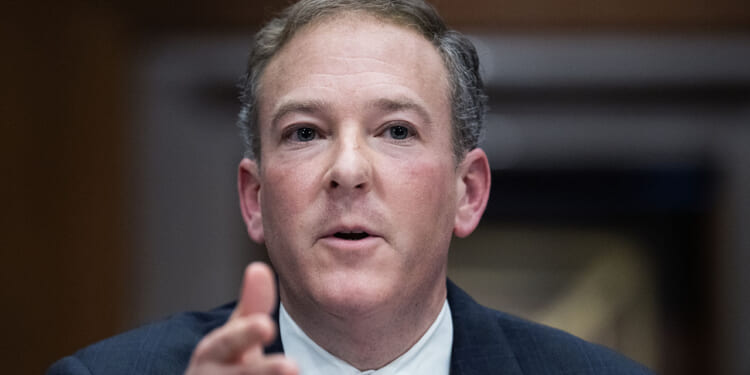 Under Administrator Lee Zeldin (pictured), the EPA is dropping greenhouse gas emission regulations established under President Joe Biden, noting that the Clean Air Act doesn't allow the EPA to regulate for climate change. Pictured: Zeldin, a man in a suit and tie speaks, gesturing with his hand. The background is out of focus.