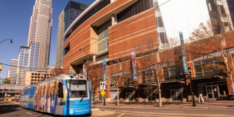 The electric light rail mass transit is seen driving through an empty city street on a sunny, but freezing cold winter day in Charlotte, North Carolina, on Dec. 16, 2025.