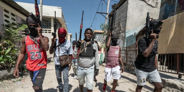 Gang leader Jimmy "Barbecue" Cherizier patrolling the streets with G-9 federation gang members in the Delmas 3 area on Feb. 22, 2024, in Port-au-Prince, Haiti.