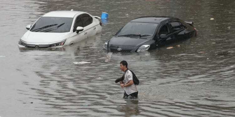 Heavy rain and flooding in Bangkok disrupts traffic and prompts evacuations