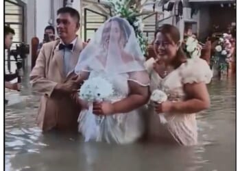 Liean Liza Chico stands in the flooded church with her parents.