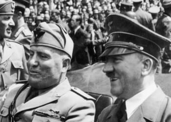 Adolf Hitler and Benito Mussolini riding in an open car in the 1940s.