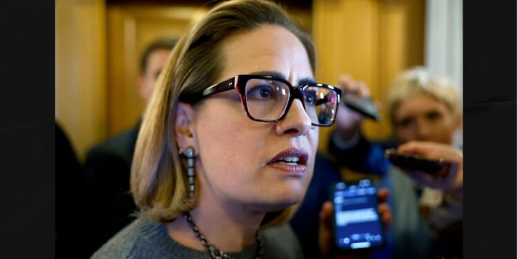 Then-Sen. Kyrsten Sinema of Arizona is seen in a 2024 photo speaking to reporters at the U.S. Capitol Building in Washington, D.C.