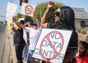 Protesters in Imperial, California, wave signs during a nationwide protest July 18 against AI data center expansion.
