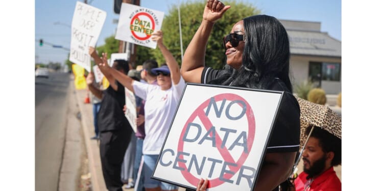 Protesters in Imperial, California, wave signs during a nationwide protest July 18 against AI data center expansion.