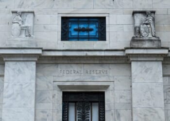 The Federal Reserve building stands in Washington, D.C. under gray skies.