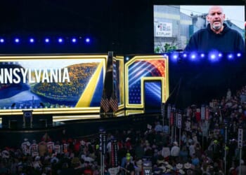 Sen. John Fetterman, a Pennsylvania Democrat, is seen on a screen as he delivers a video message Wednesday during the Republican National Midterm Convention at the American Airlines Center in Dallas, Texas.