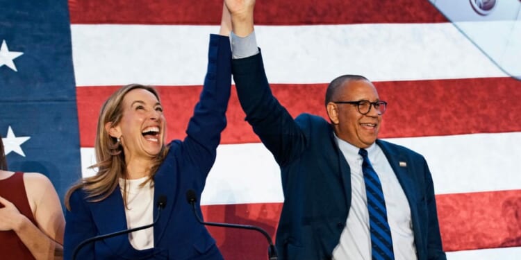New Jersey Democratic Gov. Mikie Sherrill celebrates with Lt. Gov. Dale Caldwell after their win during an election night watch party at the Hilton East Brunswick Hotel on Nov. 4, 2025, in East Brunswick, New Jersey.