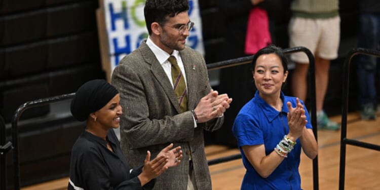 Hasan Piker stands beside Wisconsin Gubernatorial candidate Francesca Hong and Congresswoman Ilhan Omar at a rally in Milwaukee, Wisconsin.