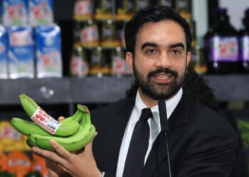 New York City Mayor Zohran Mamdani holds up bananas as he speaks at a food distribution center on July 27, 2026, in the Brooklyn borough of New York City.