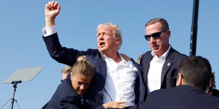 Then-Republican presidential candidate Donald Trump raises a defiant fist after the July 2024 assassination attempt on him in Butler, Pennsylvania.