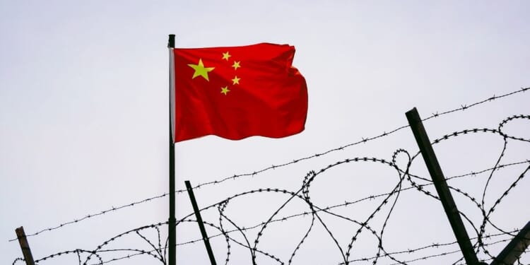 Prison bars with a Chinese flag.