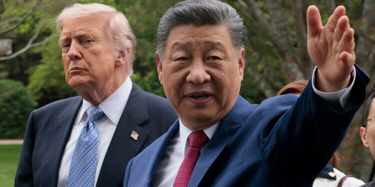 Donald Trump and Xi Jinping in suits stand outdoors; Xi gestures with his hand while the Trump looks on with a serious expression. Trees and greenery are visible in the blurred background.
