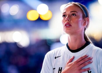 Sophie Cunningham #8 of the Indiana Fever salutes the flag Sept. 18 during the national anthem prior to play against the WNBA's Toronto Tempo in Toronto, Canada.