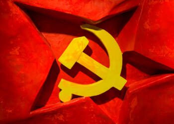 A yellow hammer and sickle symbol on a red background with a three-dimensional red star behind it, representing communism and evoking imagery associated with the Chinese Communist Party.