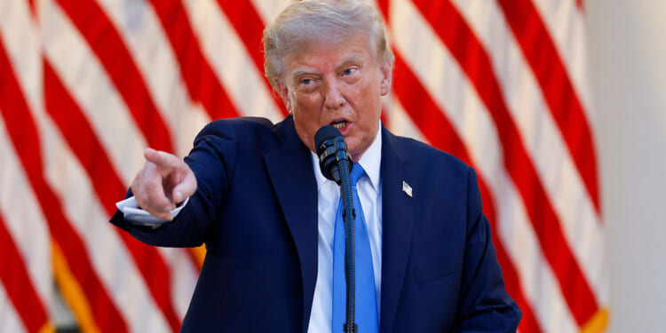 The Supreme Court rules on Trump's mail-in ballot regulations. Pictured: President Donald Trump, a man in a navy suit speaks into a microphone and points forward, with a backdrop of several American flags displayed in rows behind him.
