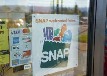 A "SNAP Welcomed Here" sign is seen at the entrance to a Big Lots store in Portland, Oregon, on Oct. 28, 2020.